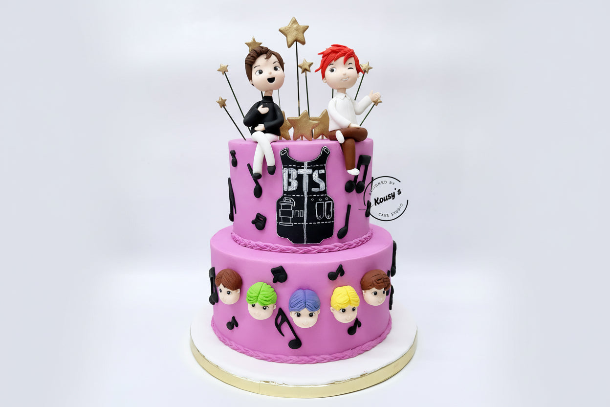 Two-tier cake with BTS-themed decorations made by Kousy's Cake studio