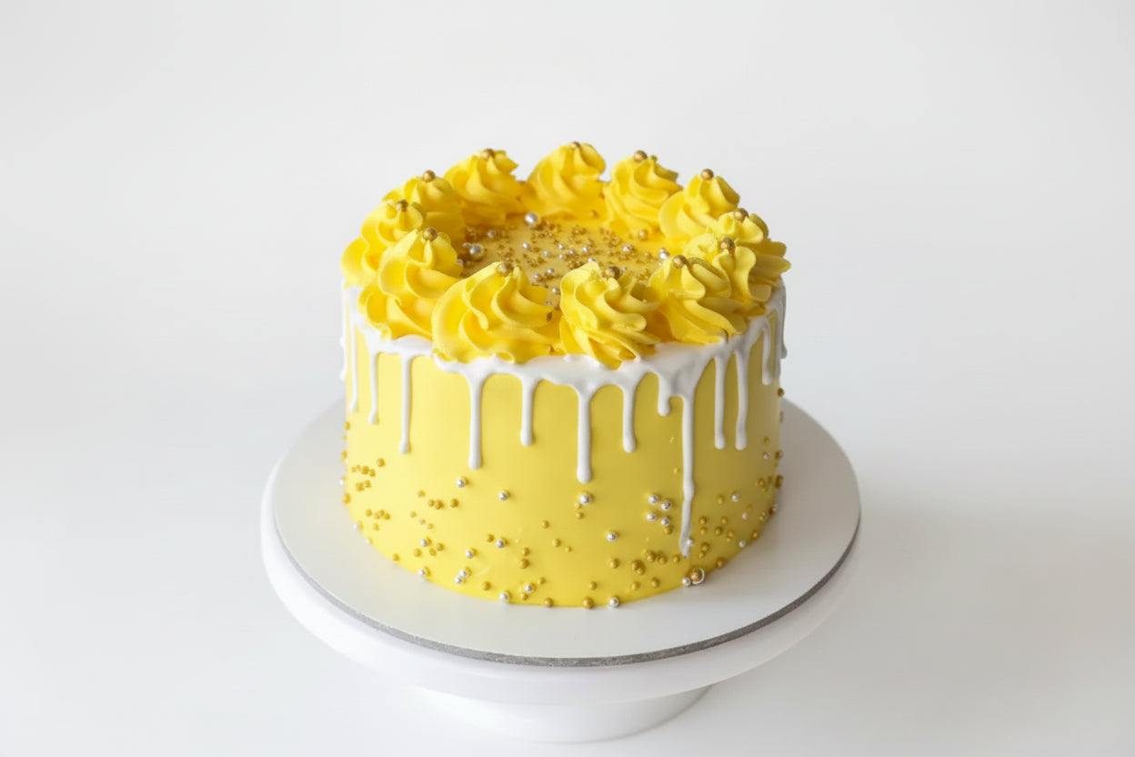 Yellow cake with white frosting on a white background